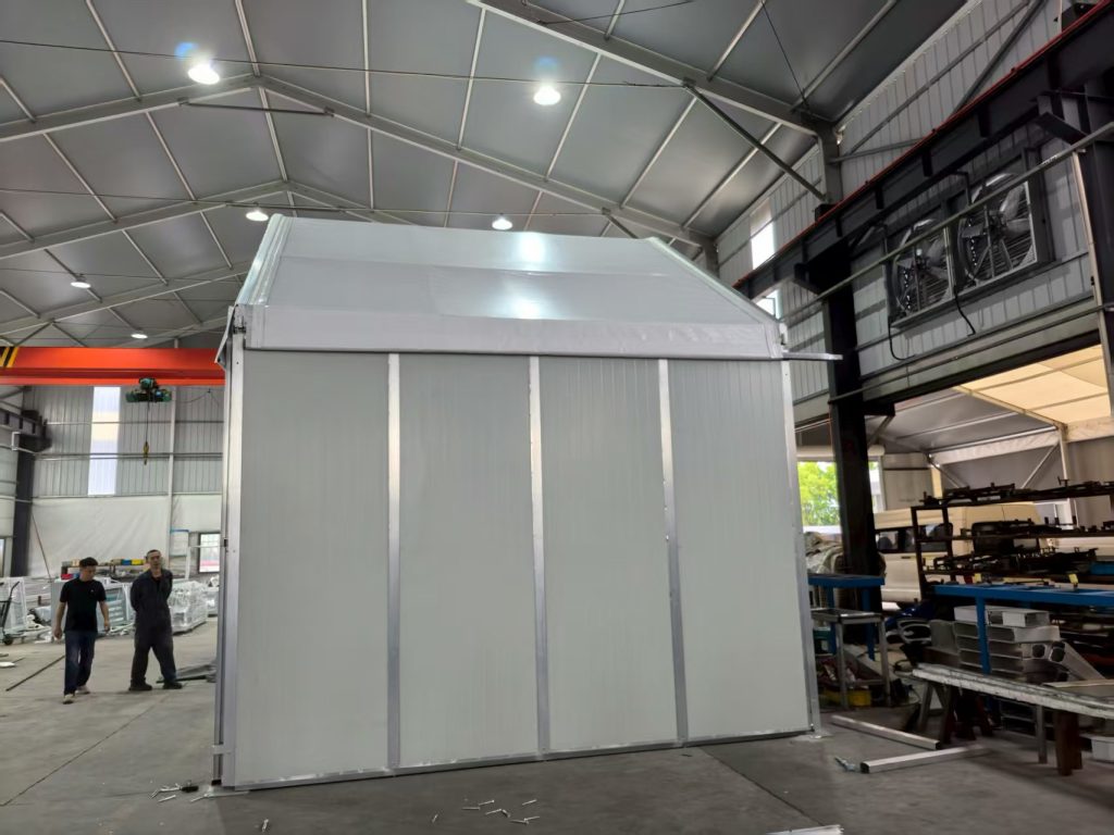 An modular insulated aluminum arch sports tent with sandwich panel walls in a winter setting