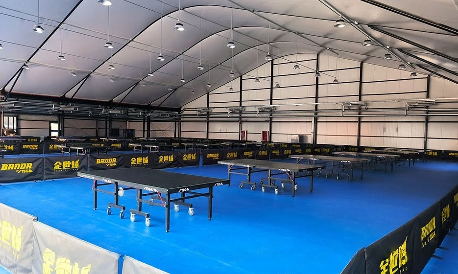 Insulated sports facility tent fieldhouse with sandwich panel walls in a Northeast winter setting