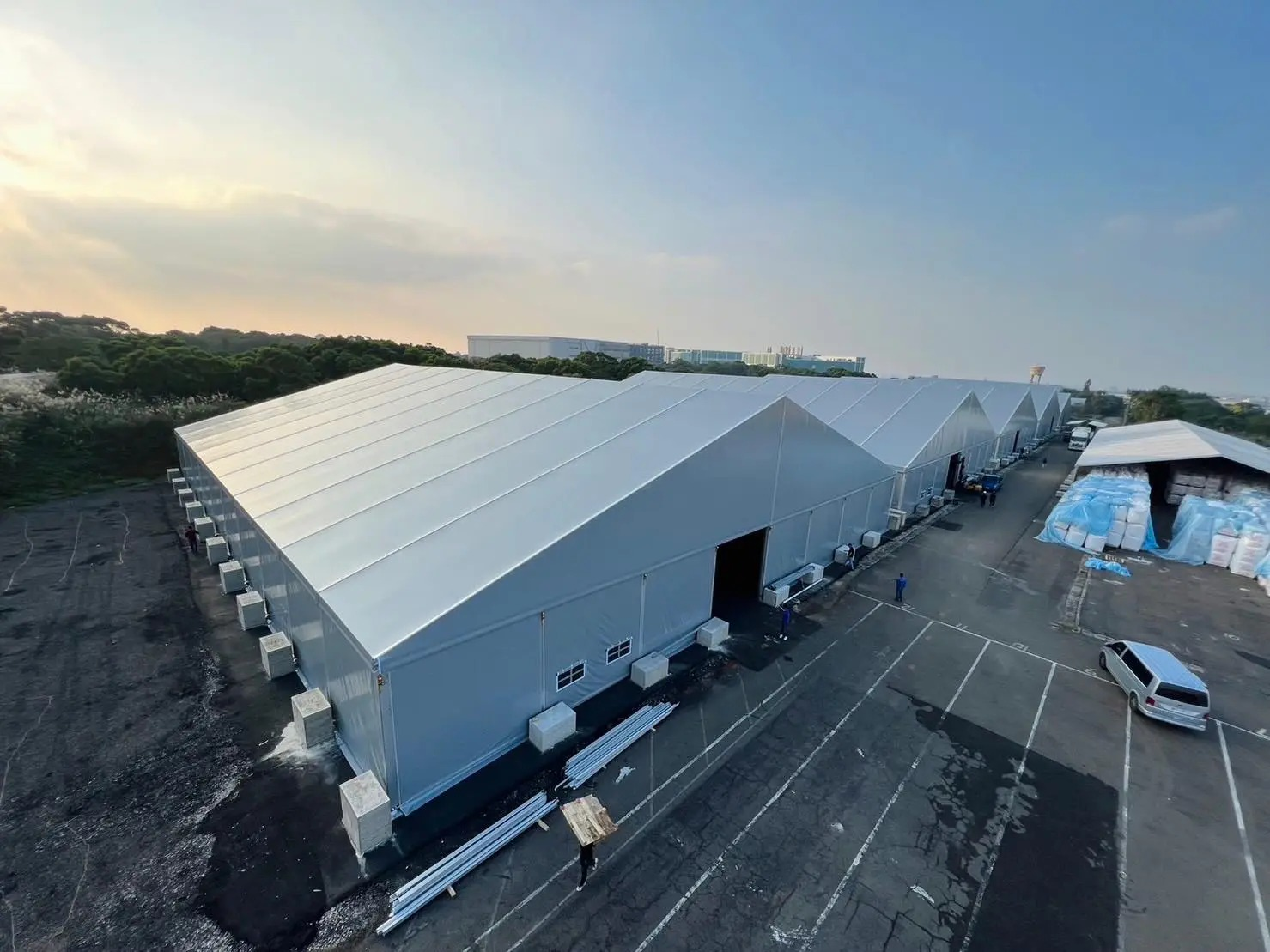 Large aluminum frame storage tent with forklift loading goods